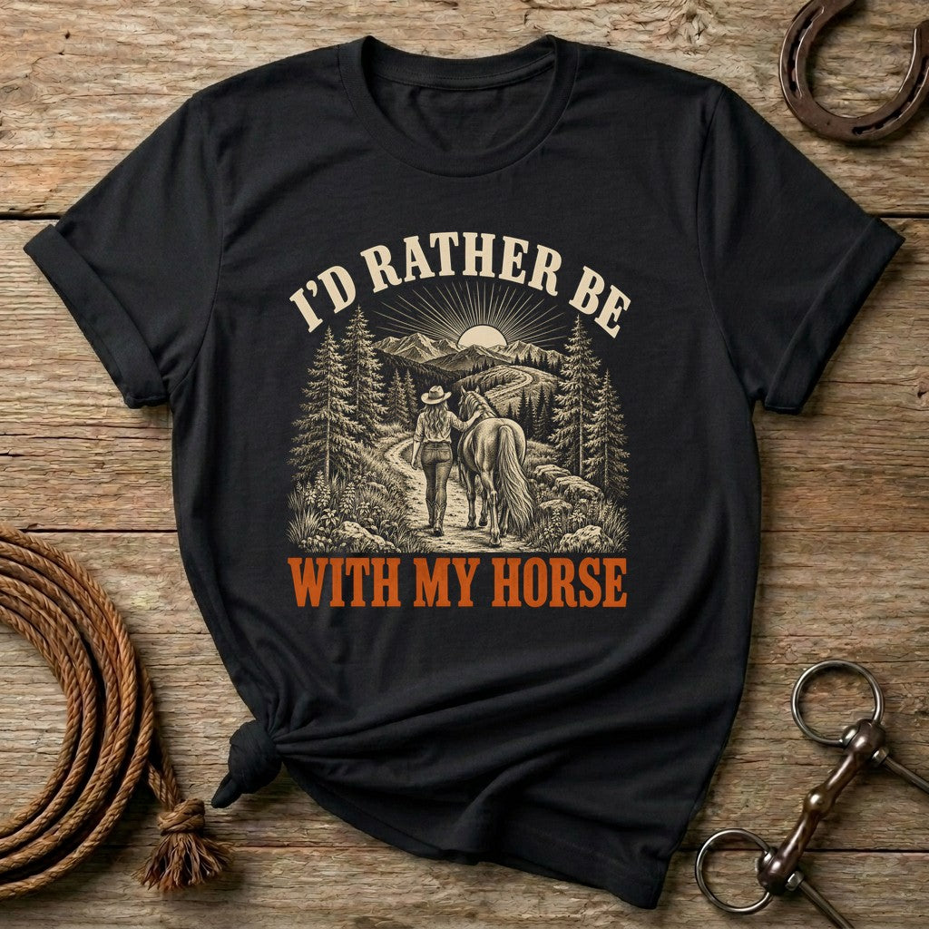 Black I'd Rather Be With My Horse t-shirt with a cowgirl walking her horse on a mountain trail