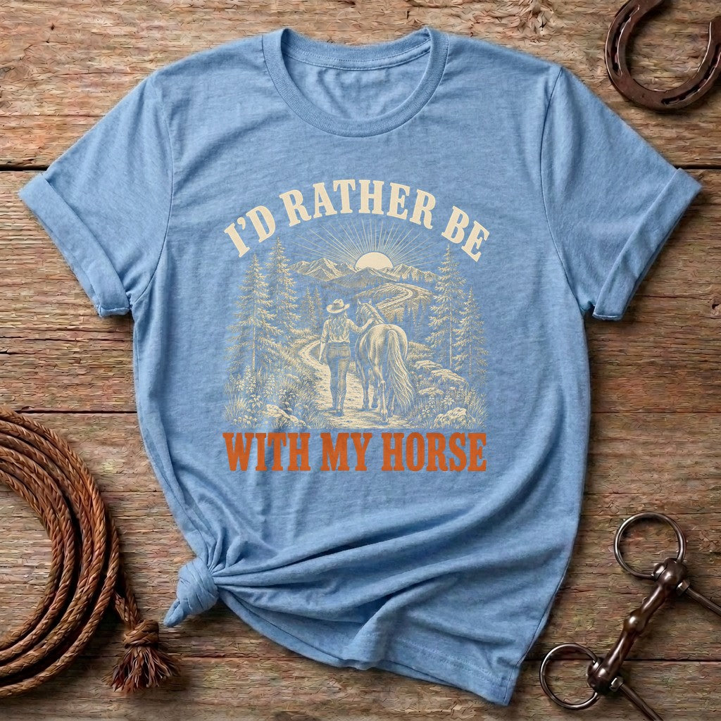 Light Blue I'd Rather Be With My Horse t-shirt with a cowgirl walking her horse on a mountain trail
