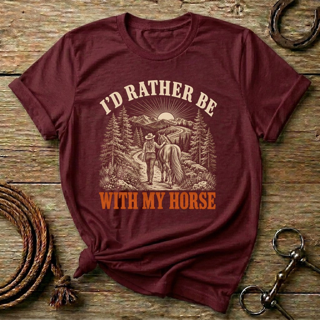 Maroon I'd Rather Be With My Horse t-shirt with a cowgirl walking her horse on a mountain trail