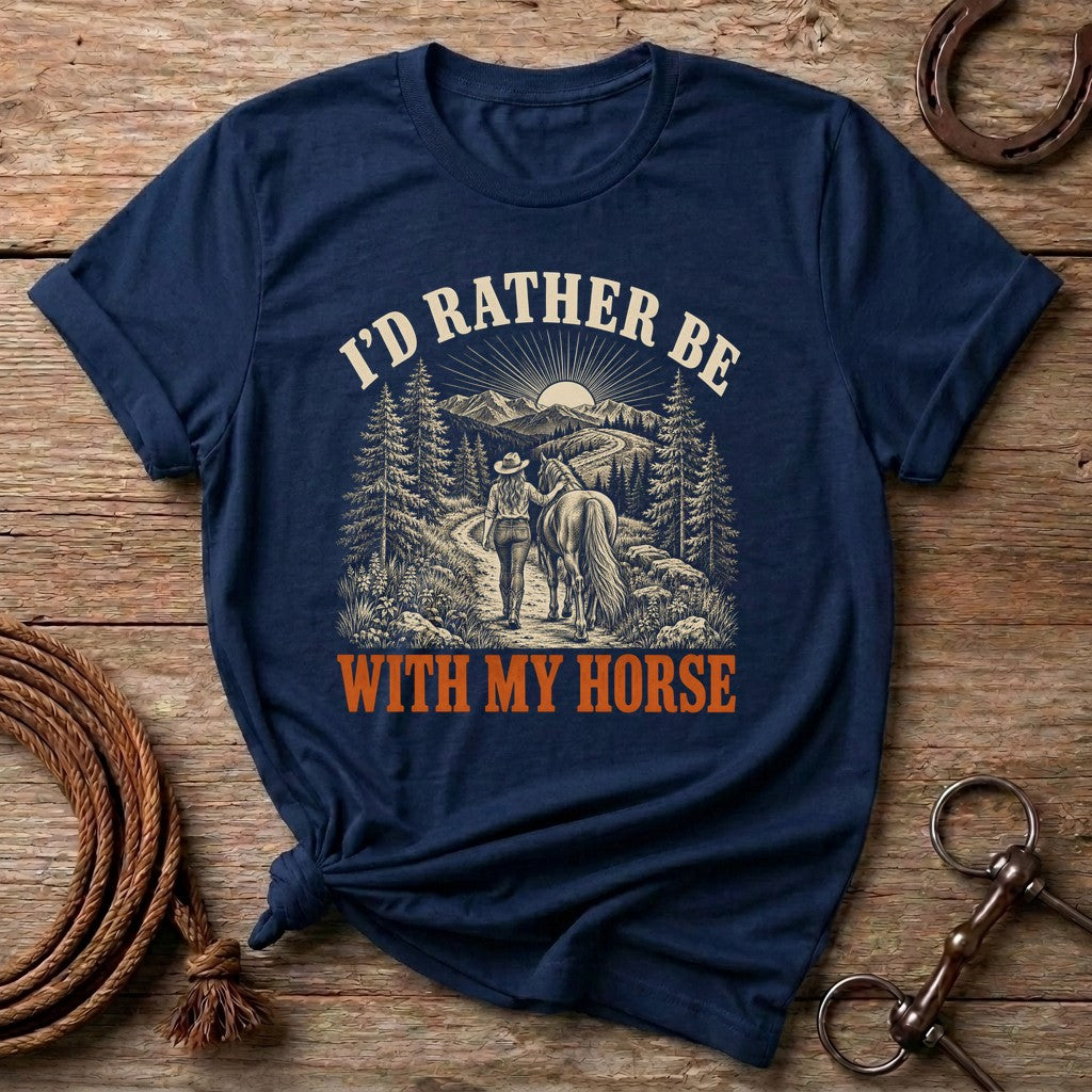 Navy I'd Rather Be With My Horse t-shirt with a cowgirl walking her horse on a mountain trail